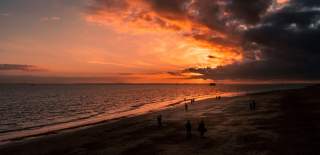 Photograph showing a fiery red sky over the Southsea Beach at dusk