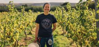 A woman standing in a vineyard in North Somerset near Bristol - credit GOOD Stories in Food