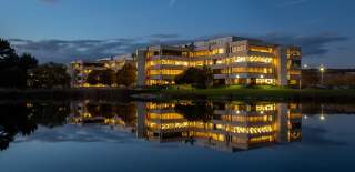Lakeside North Harbour in Portsmouth in low evening light, with the building reflected in nearby water