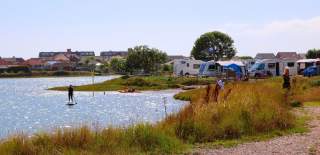 People enjoying the waterside location of Fishery Creek Caravan Park near Portsmouth