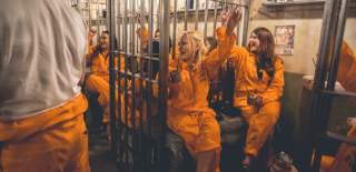 A group of women wearing orange jumpsuits in a cell - credit Alcotraz