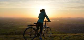 A cyclist near Cleeve Hill enjoys the stunning view across the landscape