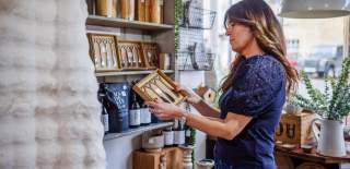 A woman looks at a gift in No.31 Burford
