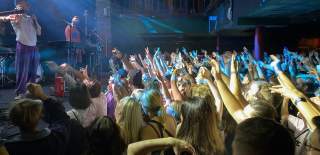 Side view of crowd of people at a music gig at The Brook