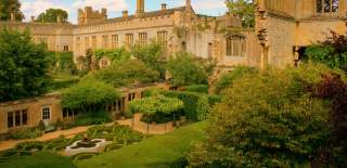 Honey-coloured Sudeley Castle surrounds the courtyard Knot Garden with shaped box hedges and trees
