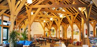 The inside of The Gateway Cafe with it's high beamed ceiling looks out over one of the lakes