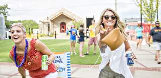 2 people tossing bean bags
