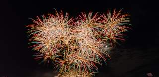 Fireworks in the night sky in front of crowd at Utilita Bowl