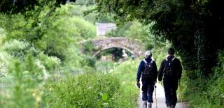 A couple of ramblers walking along the canal towpath near Stroud