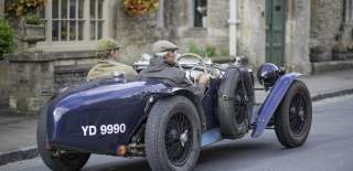 Vintage car driving through Stow on the Wold