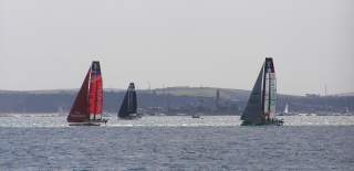 Photograph showing America's Cup catamarans racing in the Solent