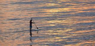 A paddleboarder out on open water