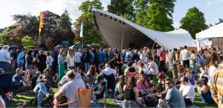 Crowds in the Festival Village at Cheltenham Jazz Festival, Montpellier Gardens, Cheltenham.