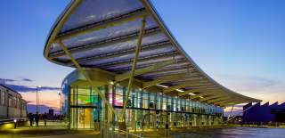 A photograph showing the Hard Interchange bus stop at dusk, from the outside