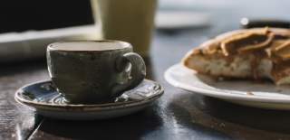 Photograph of a coffee mug and baked item at a cafe