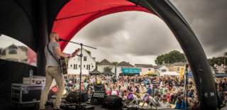 Crowd and live singer at Lymington Seafood Festival in the New Forest