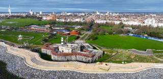 Aerial photograph looking out across the Theatre of the Sea, Southsea Castle, The D-Day Story and beyond over the Portsmouth cityscape.