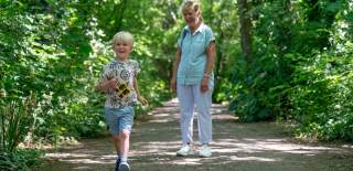 Grandparent and grandchild walking along Foxes Forest