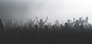 Black and white photograph of a crowd of people watching and enjoying live music