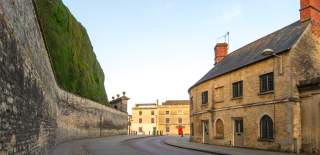 Cirencester in the Autumn with the wall and hedge to Cirencester Park on the left