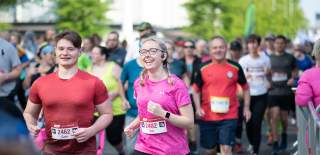 ABP Marathon runners smiling as they run past camera