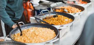 Pans full of freshly cooked rice and noodles on a market stall in Pocklington, East Yorkshire