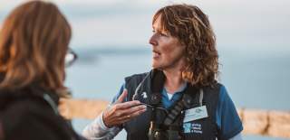 A tour guide answering questions at RSPB Bempton Cliffs