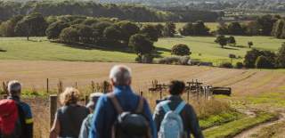 A group of walkers looking out across the Yorkshire Wolds in East Yorkshire