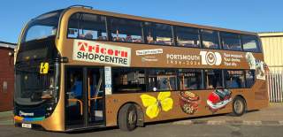Stagecoach bus with a number of items from Portsmouth Museum collection including a ceramic lion and Tricorn sign.