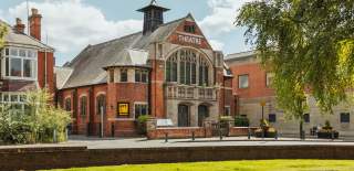 The exterior of East Riding Theatre in Beverley with the coach drop off bays in front.