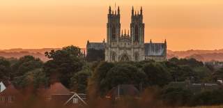 Beverley minster in the forefront with the sunset behind.