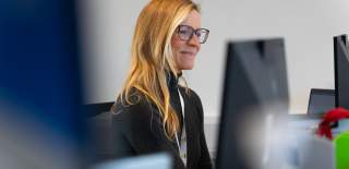 An image of a receptionist looking at their computer screen.