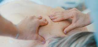 Photograph of a woman receiving a massage at a spa