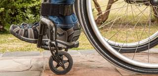 Photograph showing the bottom section of a wheelchair in use