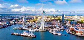 Aerial photograph showing Gunwharf Quays and Spinnaker Tower, with the Portsmouth cityscape in the distance