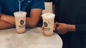 Friends show off their iced drinks from Vienna Coffee in Knoxville, TN.