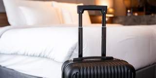 Stock Image - Suitcase and Bed - Getty Images