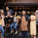 Several people sitting at a bar