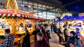 Christmas Markets at night with people in Exchange Square, Manchester