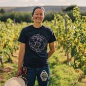 A woman standing in a vineyard in North Somerset near Bristol - credit GOOD Stories in Food