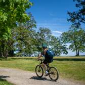 A person biking on a gravel trail.