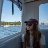 A person looking out of the window of a ferry.