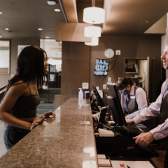 A person checking into the front desk of a hotel.
