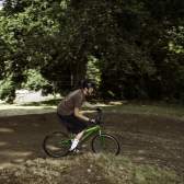 A person on a mountain bike riding down a dirt trail.