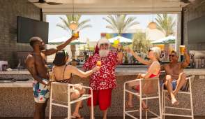 Santa with a group of friends having drinks in Palm Springs.