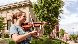 Woman Playing Violin Outside In St. Charles, MO
