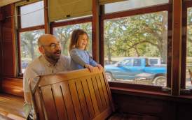 A father and daughter enjoying the St. Charles Avenue Streetcar together