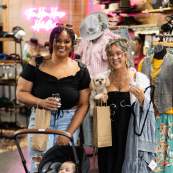 Friends shopping together and sipping during the Art Stomp event in 2025