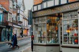 People walking on Lyndhurst high street outside the Antiques Shop in the New Forest