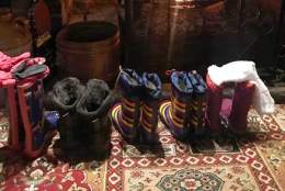 Line of wellie boots in front of fire at Waterloo Arms pub in Lyndhurst in the New Forest - Pub walks insp